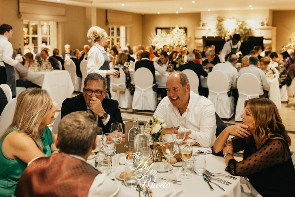 Lachende gasten aan tafel